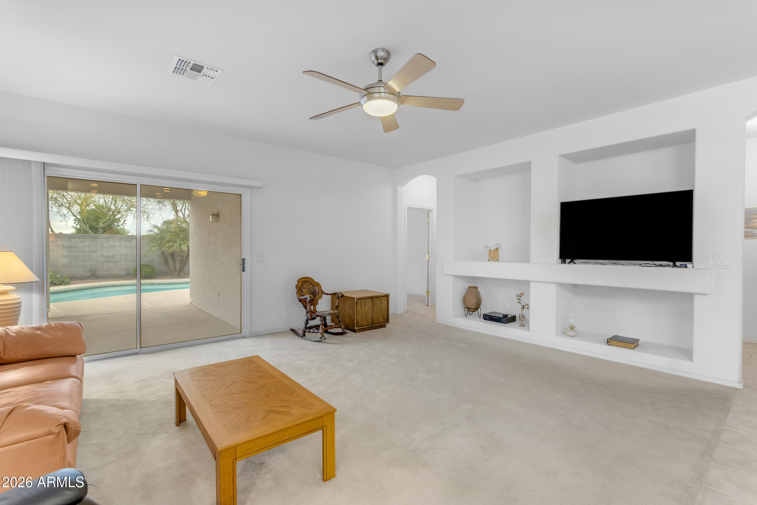 3724 East Derringer Way Gilbert, AZ 85297 - Photo 8 of 45 a living room with furniture and a flat screen tv