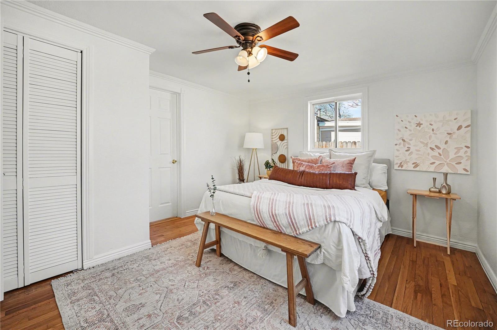 4870 Raritan Street Denver, CO 80221 - Photo 13 of 21 a bedroom with a bed and a table in it