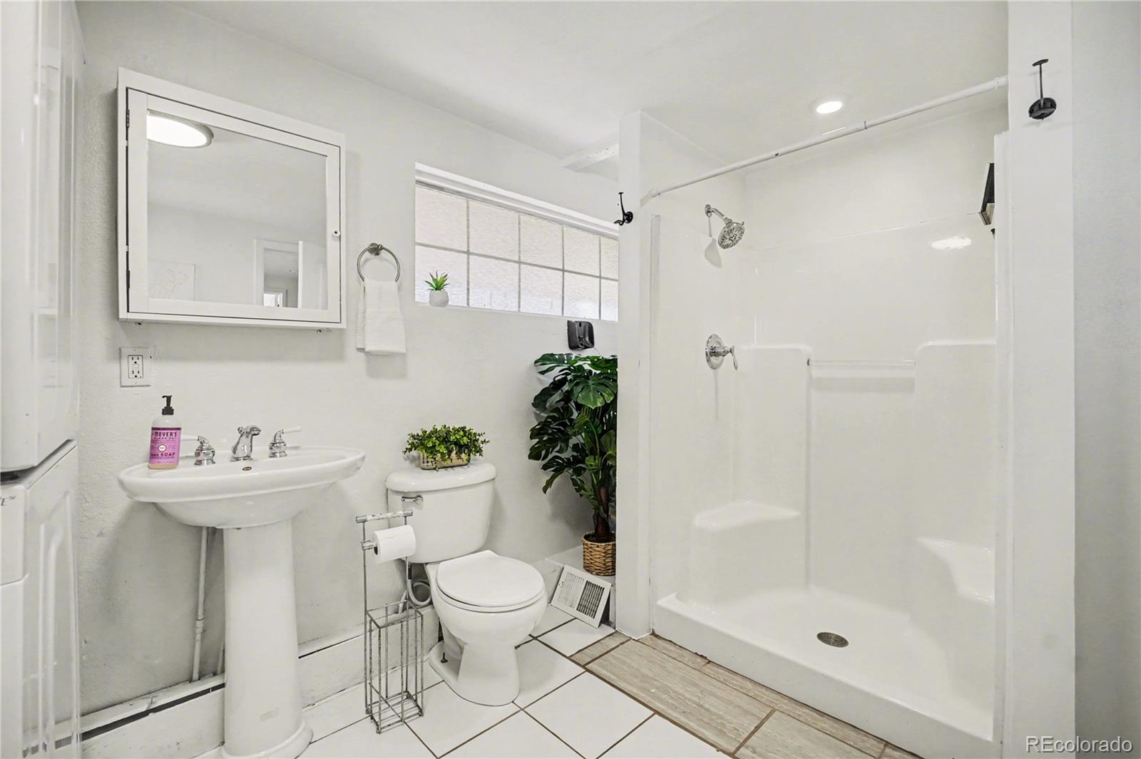 4870 Raritan Street Denver, CO 80221 - Photo 14 of 21 a bathroom with a sink toilet and shower