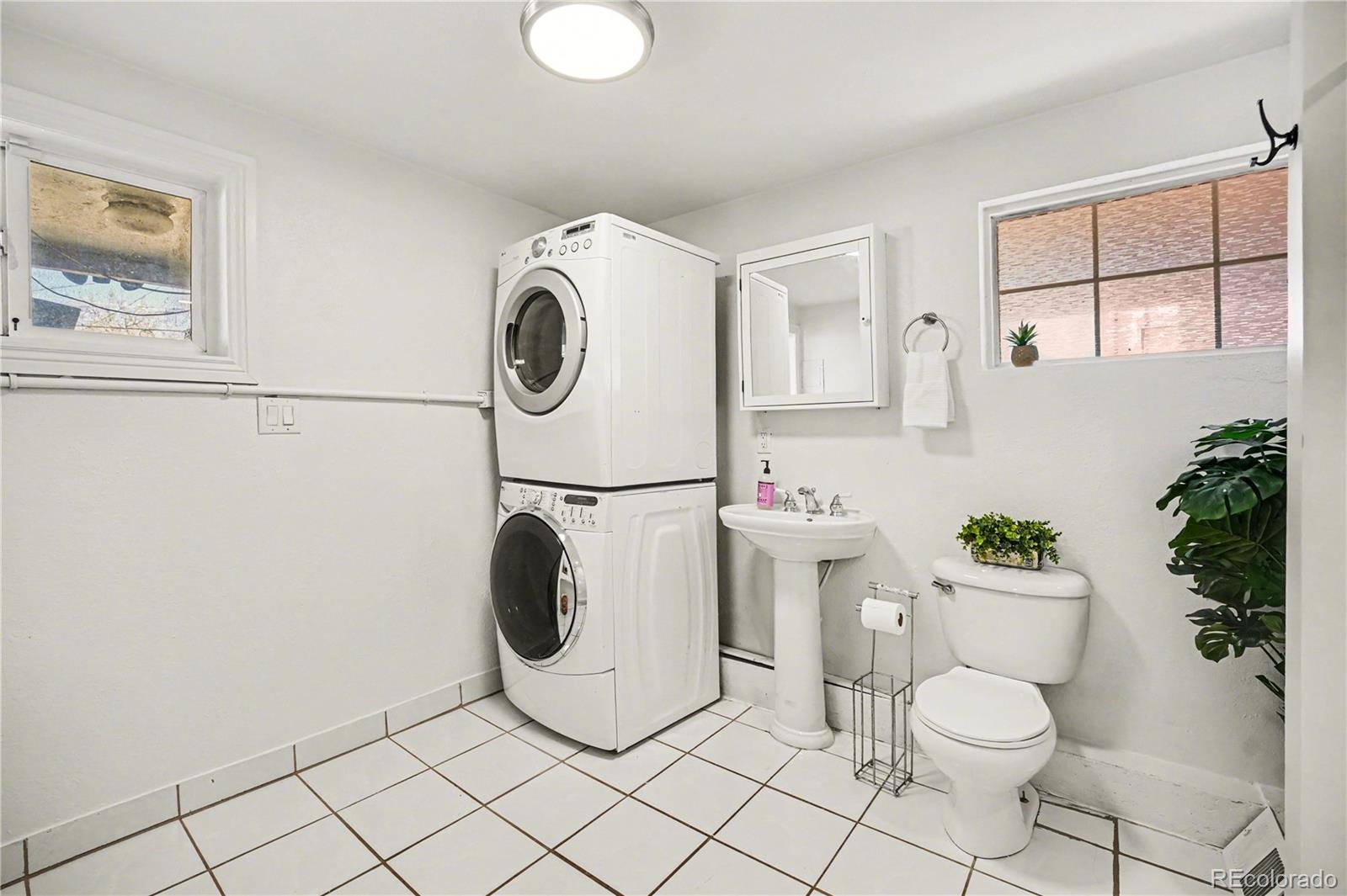 4870 Raritan Street Denver, CO 80221 - Photo 15 of 21 a bathroom with a sink toilet and mirror