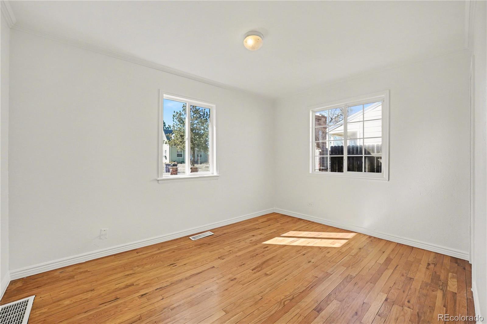 4870 Raritan Street Denver, CO 80221 - Photo 16 of 21 a view of empty room with wooden floor and fan