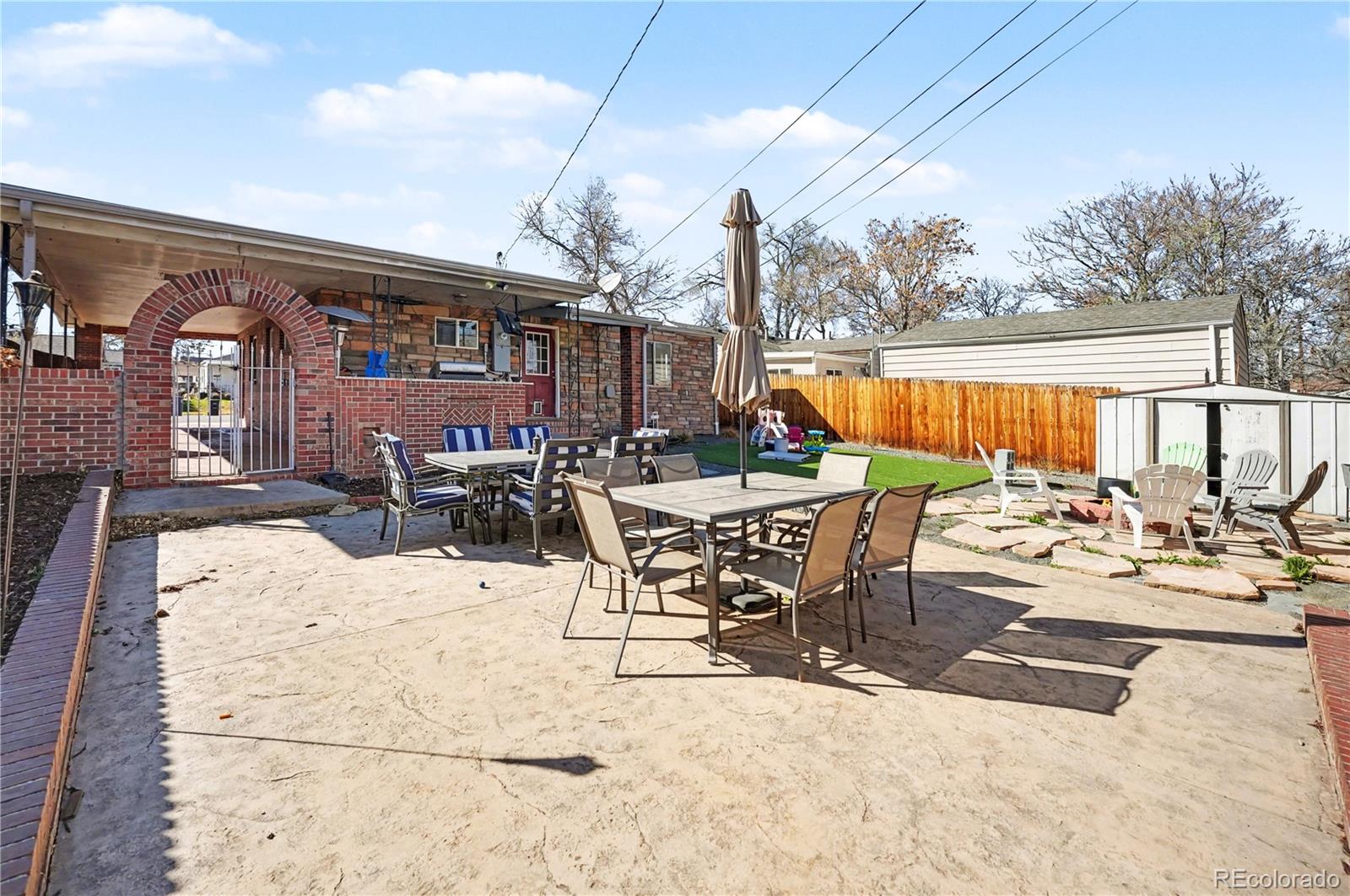 4870 Raritan Street Denver, CO 80221 - Photo 21 of 21 a view of a patio with a dining table and chairs with wooden floor