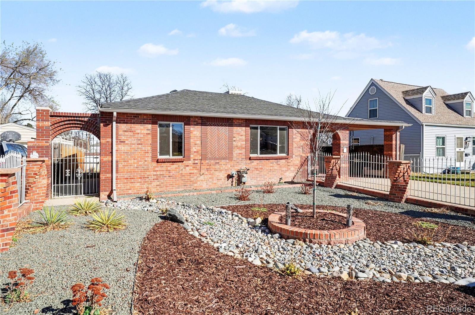 4870 Raritan Street Denver, CO 80221 - Photo 3 of 21 a front view of a house with garden