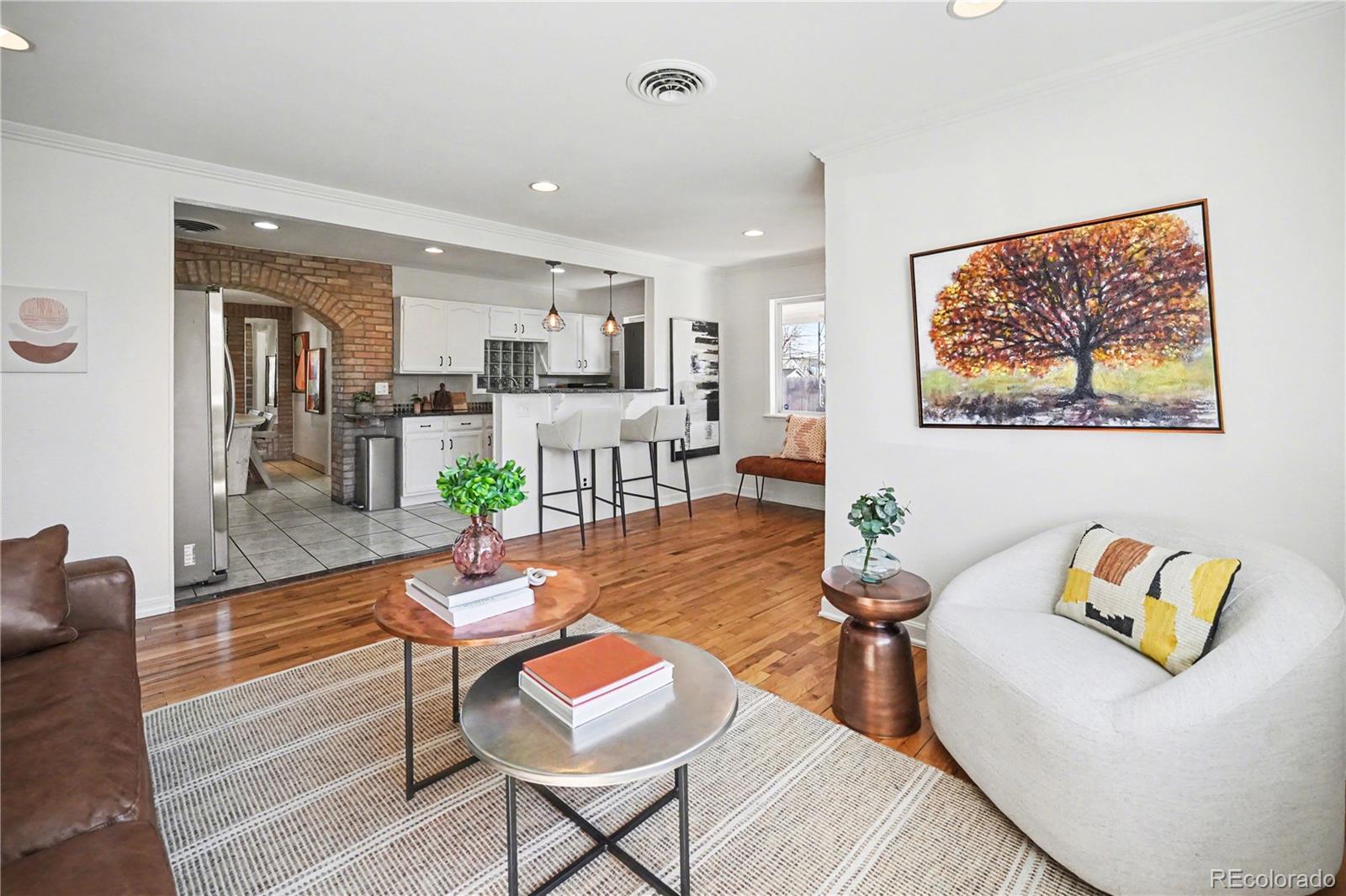 4870 Raritan Street Denver, CO 80221 - Photo 5 of 21 a living room with dining room and wooden floor