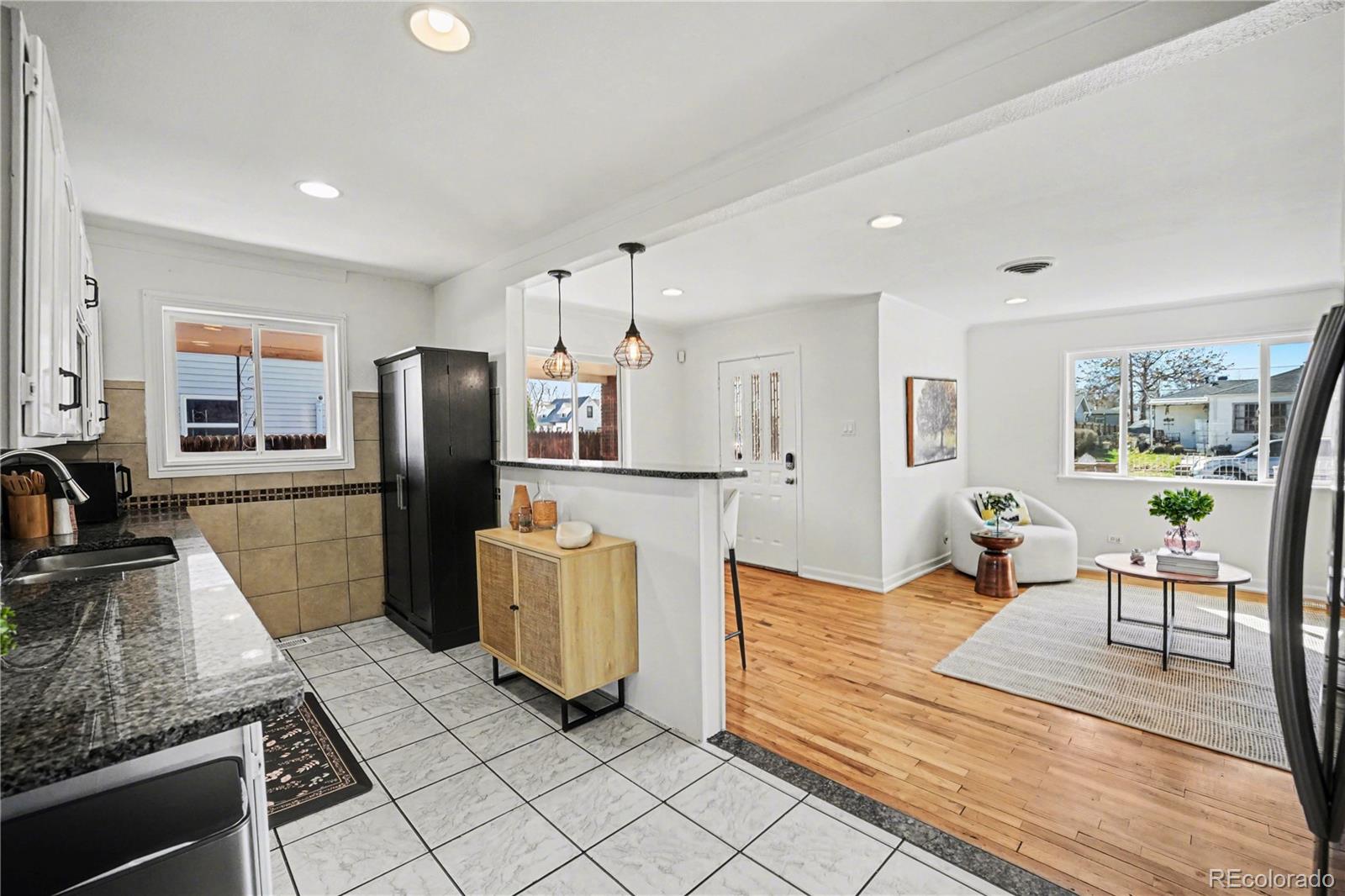 4870 Raritan Street Denver, CO 80221 - Photo 10 of 21 a kitchen with stainless steel appliances granite countertop a refrigerator and a stove top oven