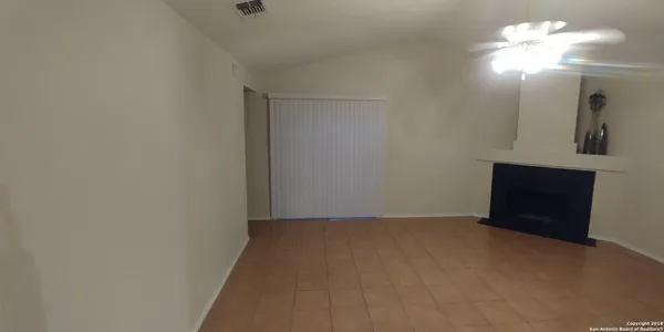 a view of an empty room with a mirror