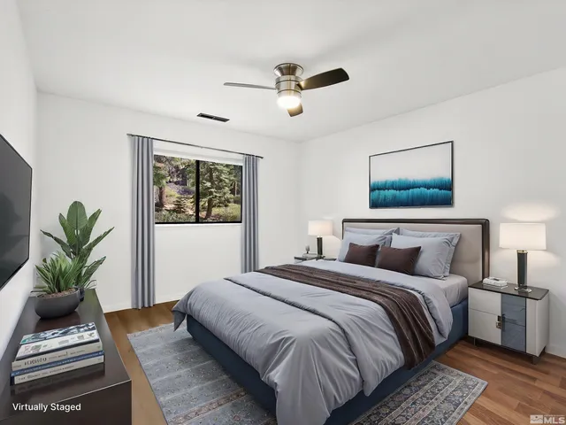 a view of a big room with wooden floor and windows