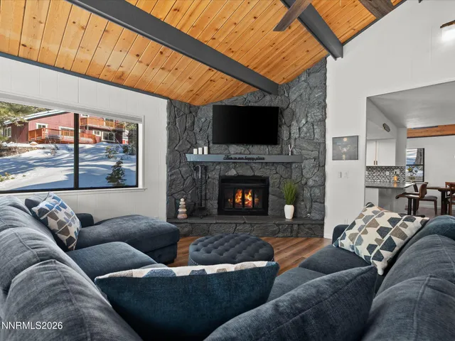 a view of a livingroom with furniture and a large window