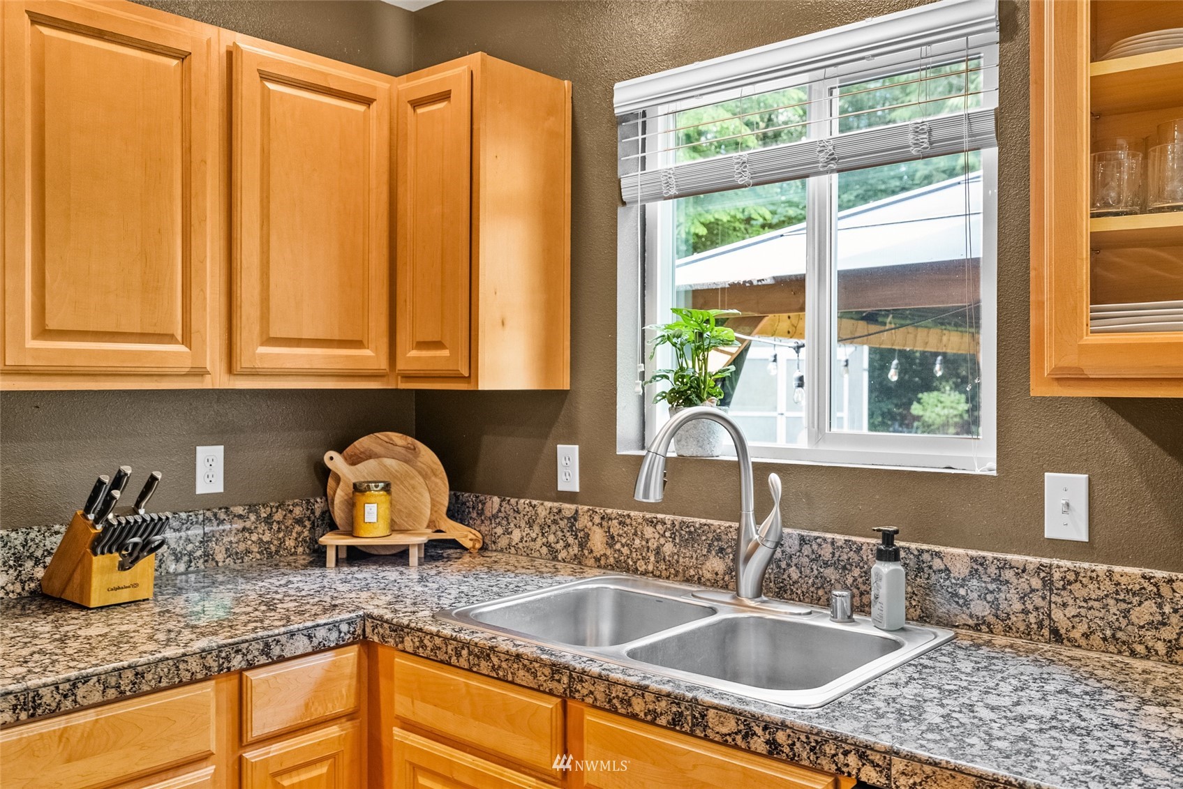 6741 Northwest Ranger Way Silverdale, WA 98383 - Photo 13 of 38 a kitchen with granite countertop a sink and a window