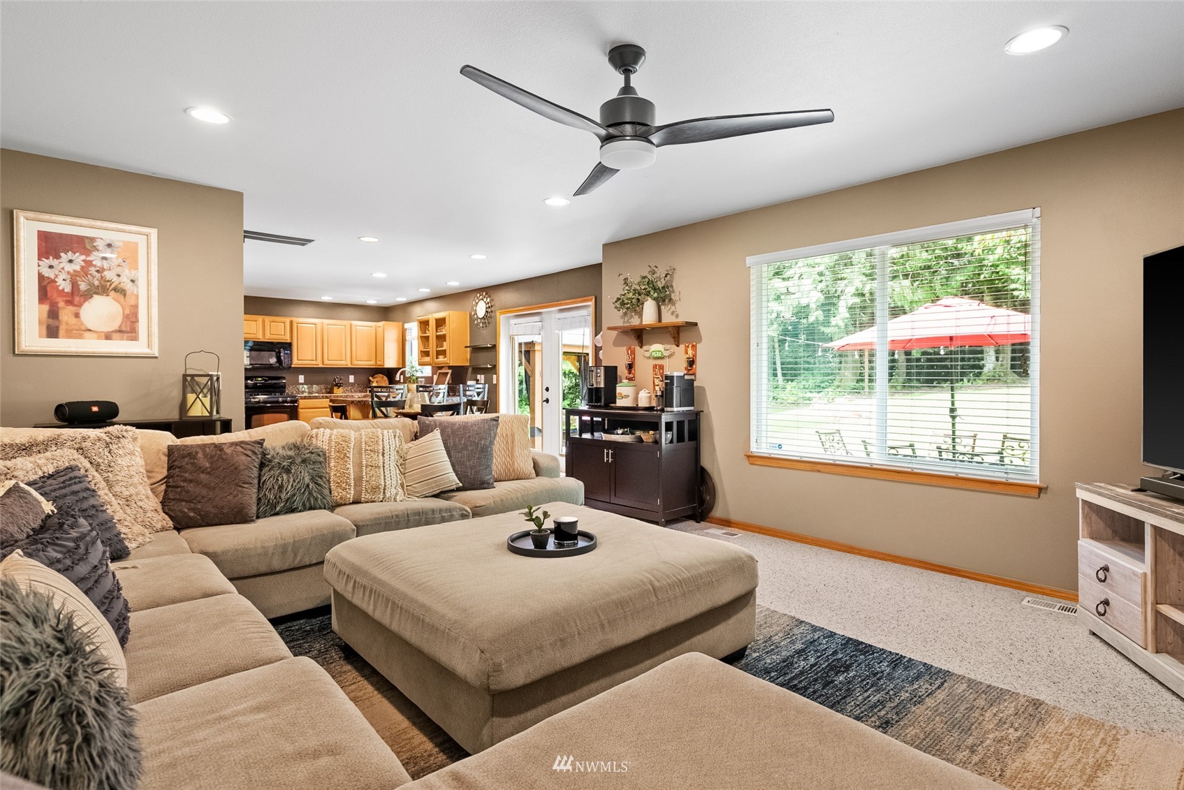 6741 Northwest Ranger Way Silverdale, WA 98383 - Photo 17 of 38 a living room with furniture a large window with kitchen view