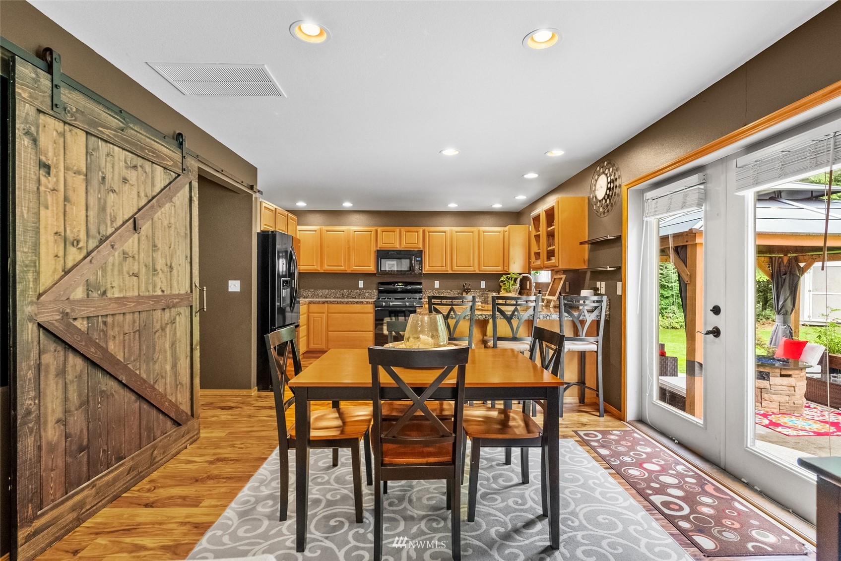 6741 Northwest Ranger Way Silverdale, WA 98383 - Photo 18 of 38 a dining room with furniture and a floor to ceiling window