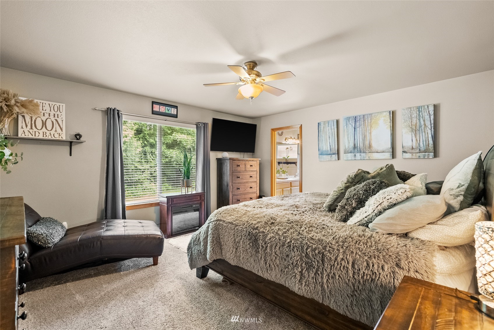 6741 Northwest Ranger Way Silverdale, WA 98383 - Photo 20 of 38 a bedroom with a bed and a chandelier