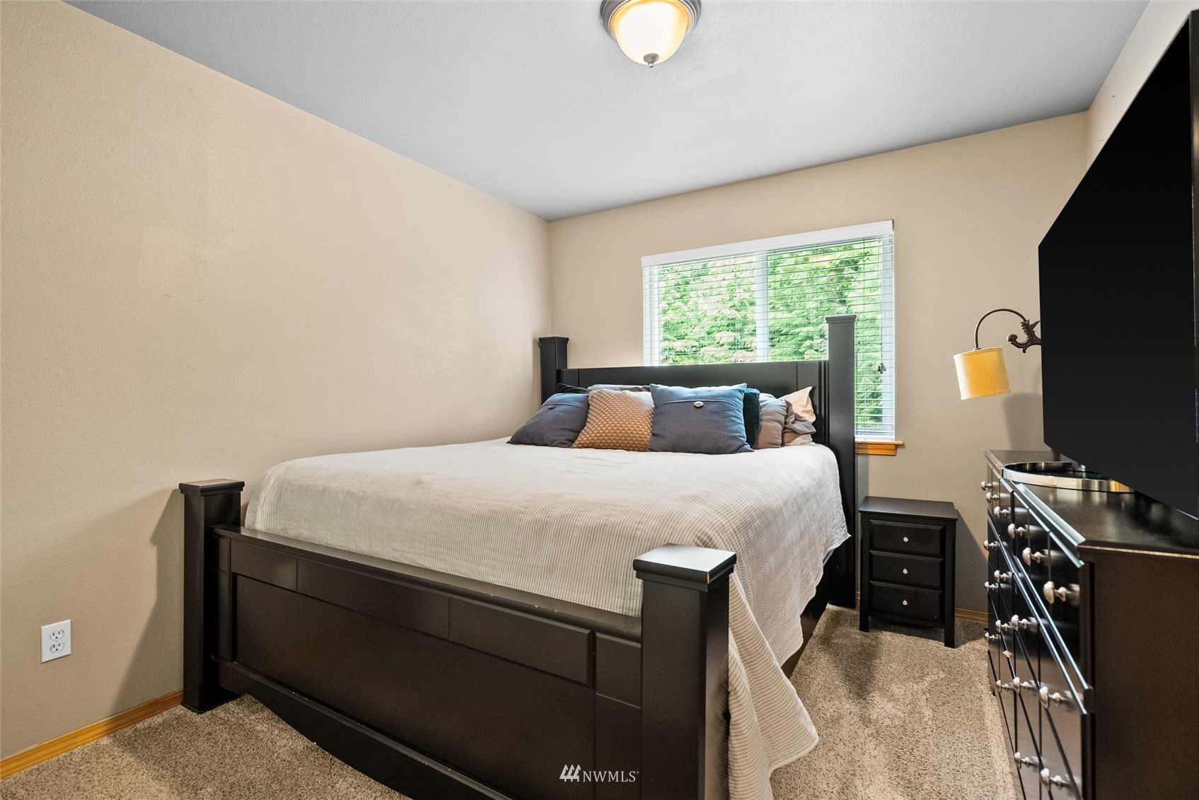 6741 Northwest Ranger Way Silverdale, WA 98383 - Photo 27 of 38 a bed sitting in a bedroom next to a window