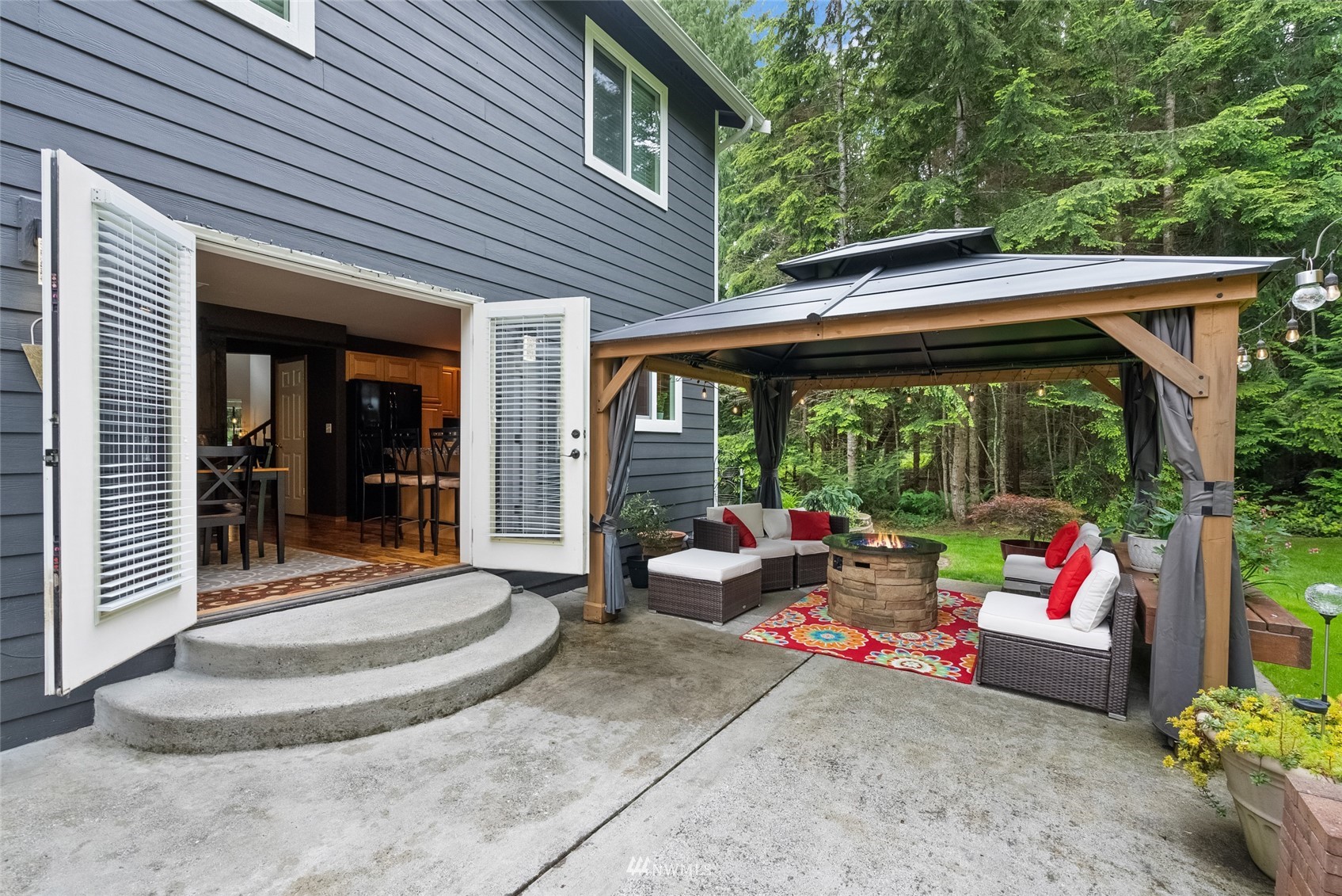 6741 Northwest Ranger Way Silverdale, WA 98383 - Photo 33 of 38 a backyard of a house with garden and outdoor seating