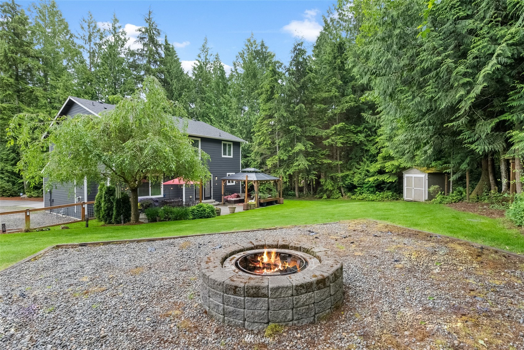 6741 Northwest Ranger Way Silverdale, WA 98383 - Photo 37 of 38 a view of a house with a backyard and a patio