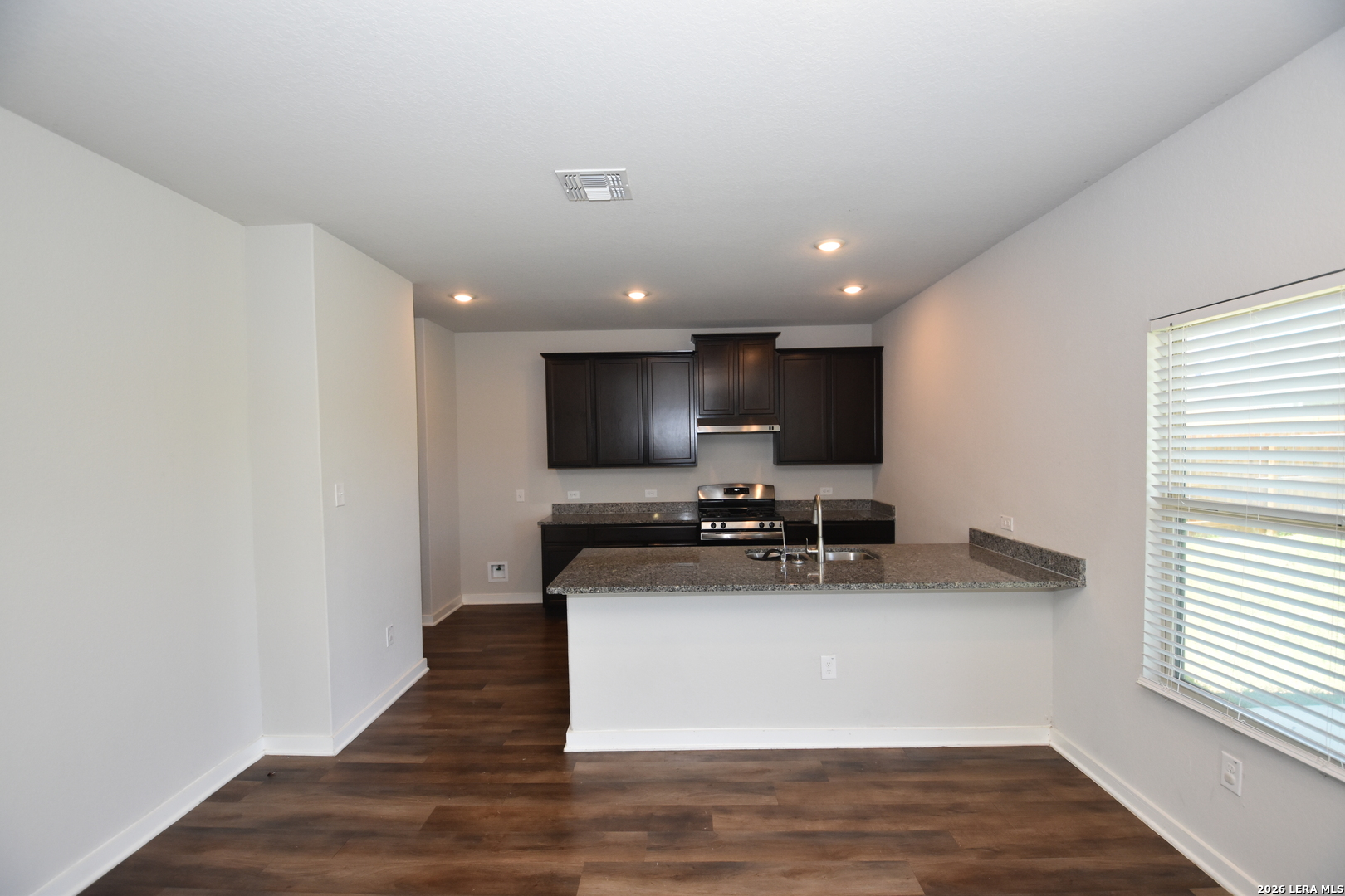 9111 Spigel Way Converse, TX 78109 - Photo 6 of 24 a view of kitchen with microwave stove refrigerator and cabinets