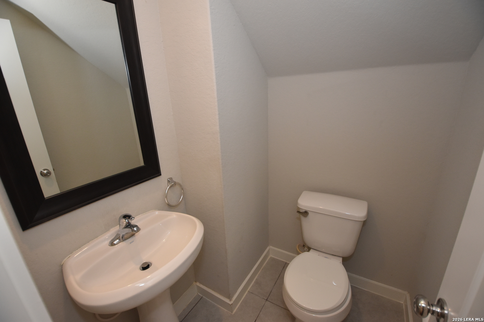9111 Spigel Way Converse, TX 78109 - Photo 8 of 24 a white toilet sitting next to a bathroom sink