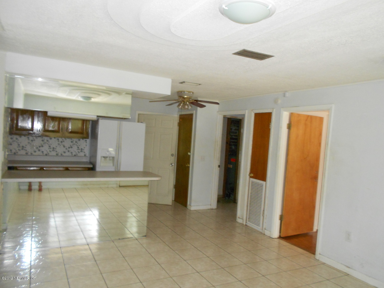LIVING ROOM. GLEAMING TILE FLOORS