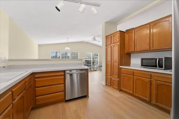 a kitchen with stainless steel appliances granite countertop a stove a sink and a refrigerator
