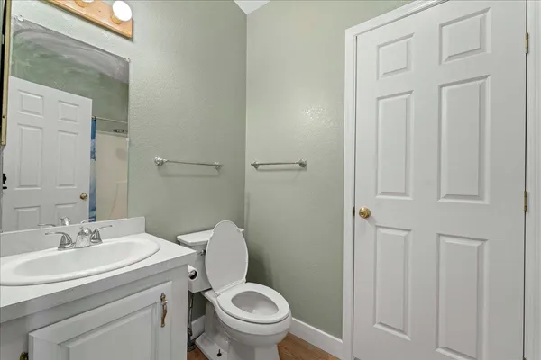 a bathroom with a sink a toilet and a mirror