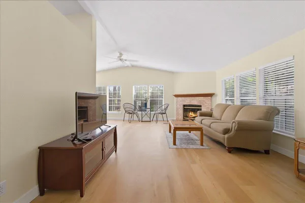 a living room with furniture a fireplace and a flat screen tv