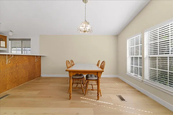 a view of a dining room with furniture and window