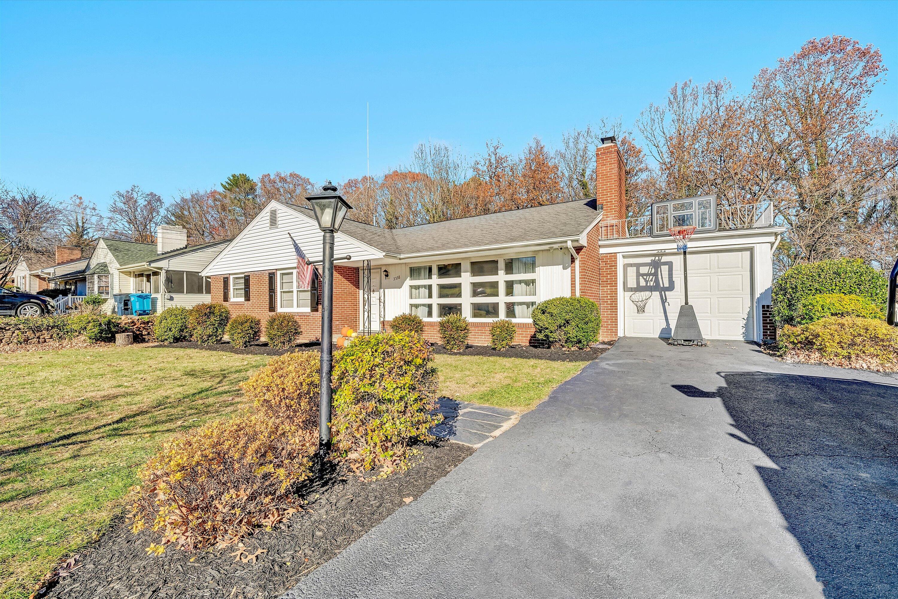 3558 Wright Road Southwest Roanoke, VA 24015 - Photo 3 of 30 a front view of a house with a yard and seating space