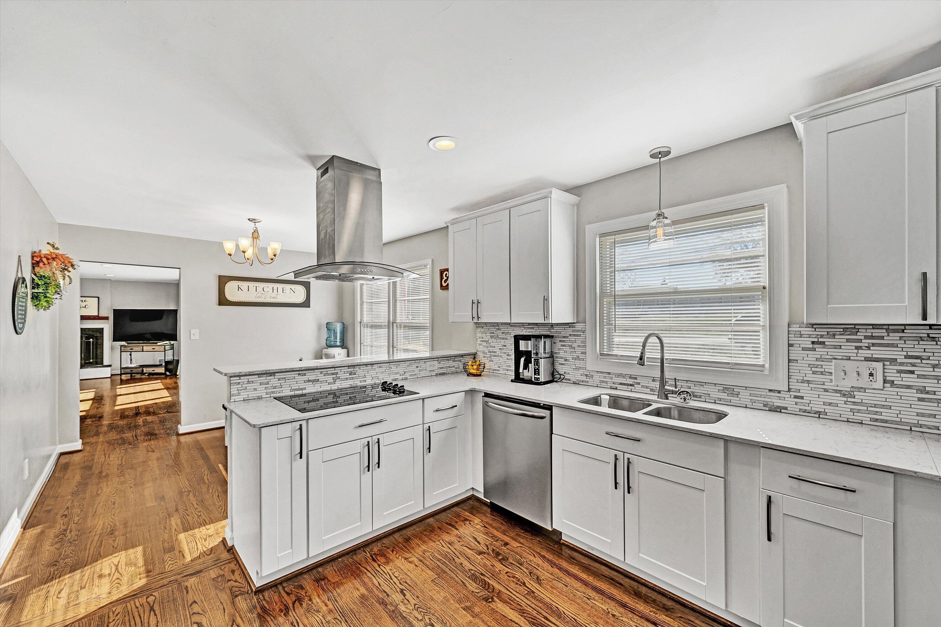3558 Wright Road Southwest Roanoke, VA 24015 - Photo 9 of 30 a kitchen with a sink stove cabinets and wooden floor