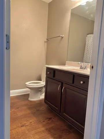 a bathroom with a sink a toilet a mirror and vanity