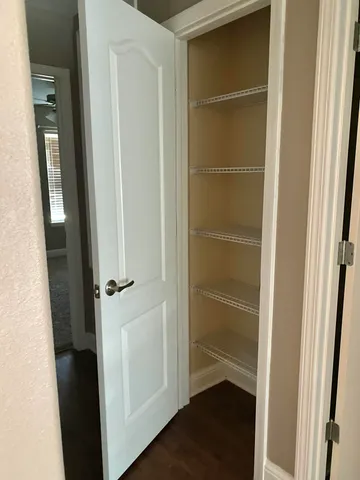 a view of a livingroom with a ceiling fan and window