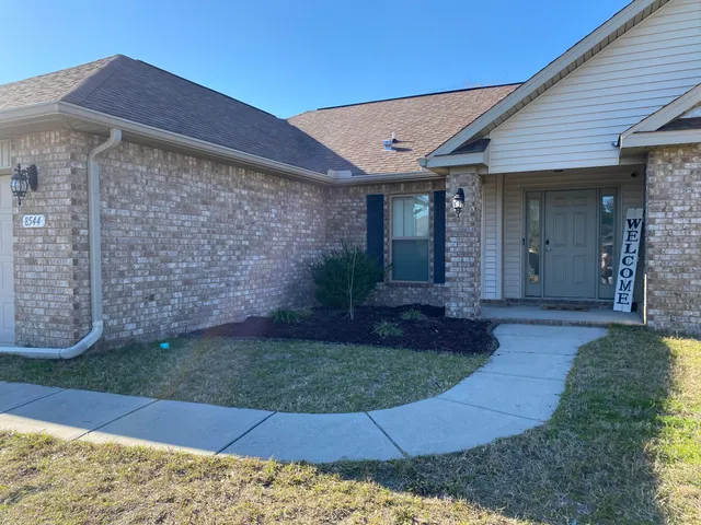 a view of a house with a yard