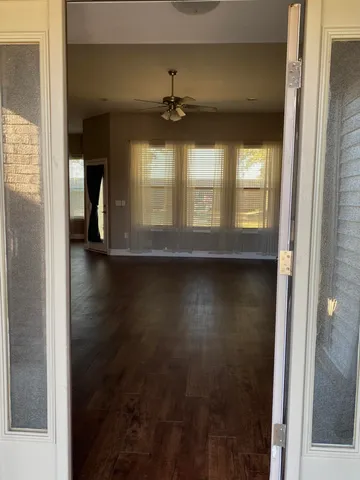 a view of a livingroom with wooden floor and a window