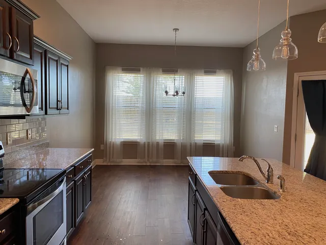 a kitchen with granite countertop a stove and a sink