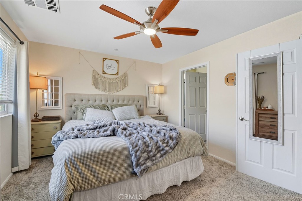 21711 Doss Place Saugus, CA 91350 - Photo 11 of 27 a bedroom with a large bed and a chandelier