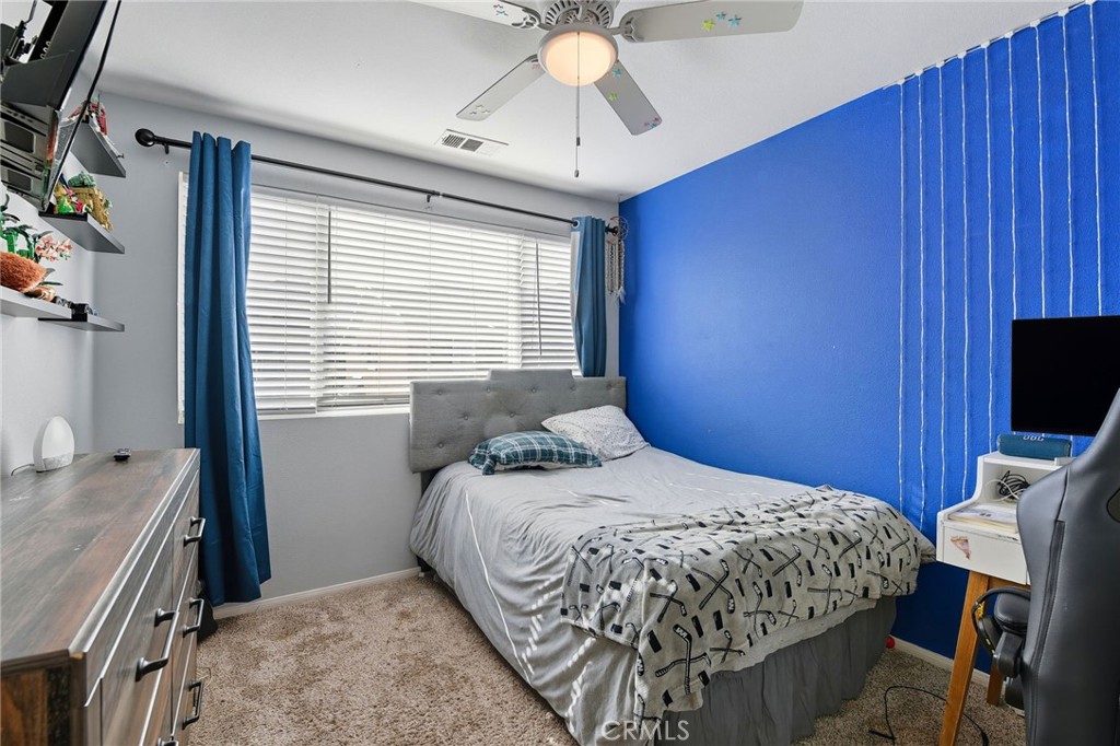 21711 Doss Place Saugus, CA 91350 - Photo 14 of 27 a bedroom with a bed and a chandelier