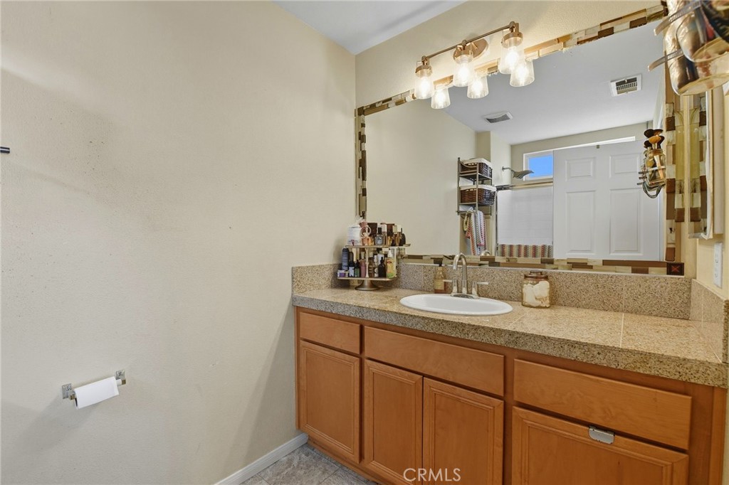 21711 Doss Place Saugus, CA 91350 - Photo 16 of 27 a bathroom with a sink and a mirror