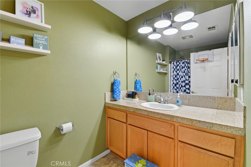 21711 Doss Place Saugus, CA 91350 - Photo 18 of 27 a bathroom with a sink and a mirror
