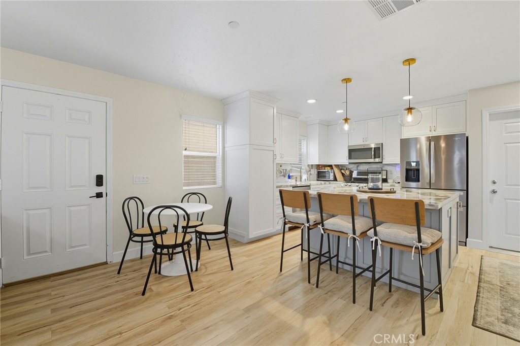 21711 Doss Place Saugus, CA 91350 - Photo 4 of 27 a view of a dining room with furniture and wooden floor