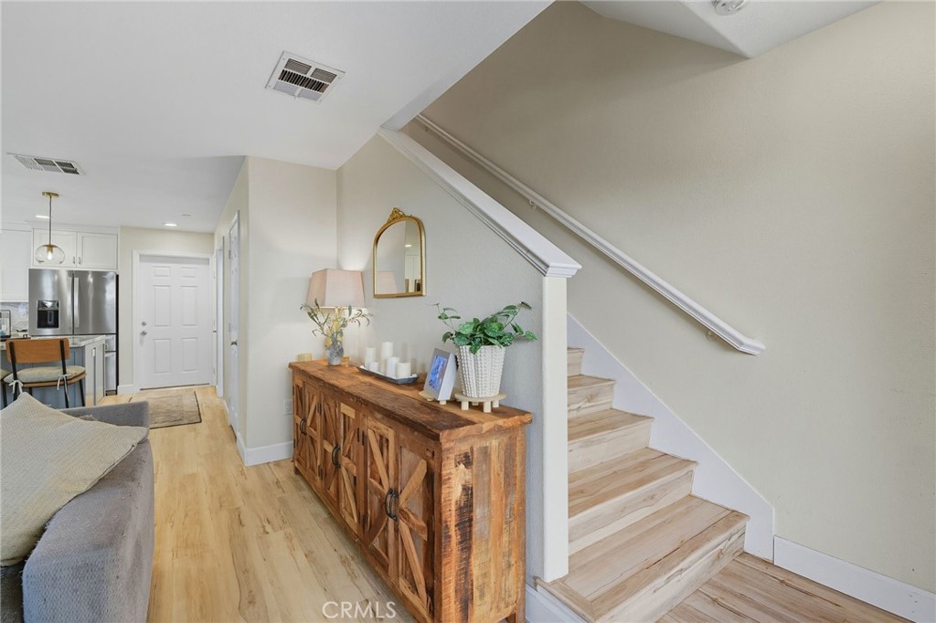 21711 Doss Place Saugus, CA 91350 - Photo 9 of 27 a view of a hallway with wooden floor and staircase