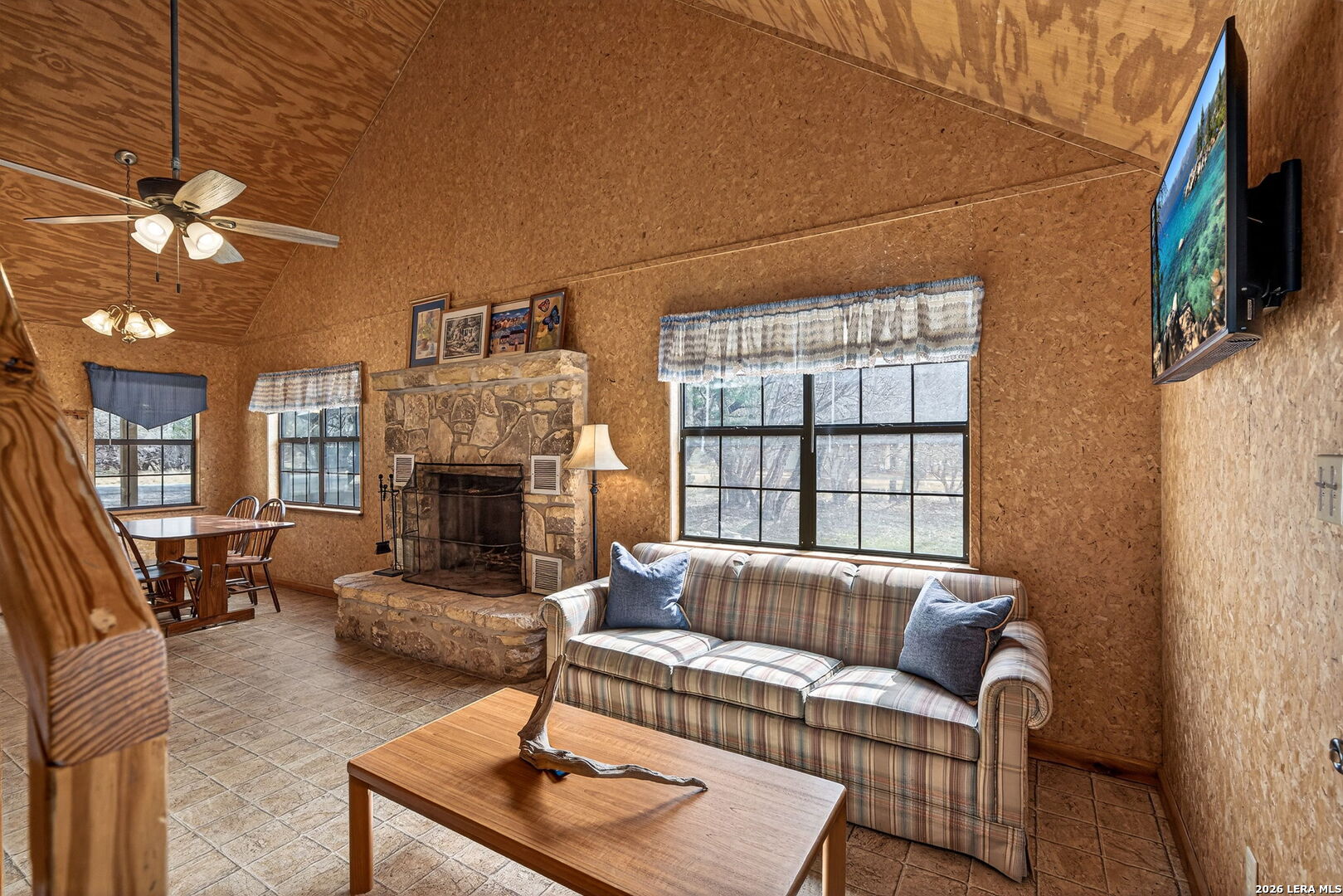 15 Cedar Lane Concan, TX 78838 - Photo 14 of 50 a living room with furniture a fireplace and a flat screen tv