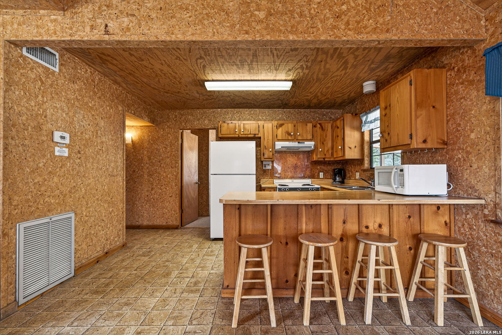 15 Cedar Lane Concan, TX 78838 - Photo 14 of 49 a kitchen with a dining table chairs and cabinets