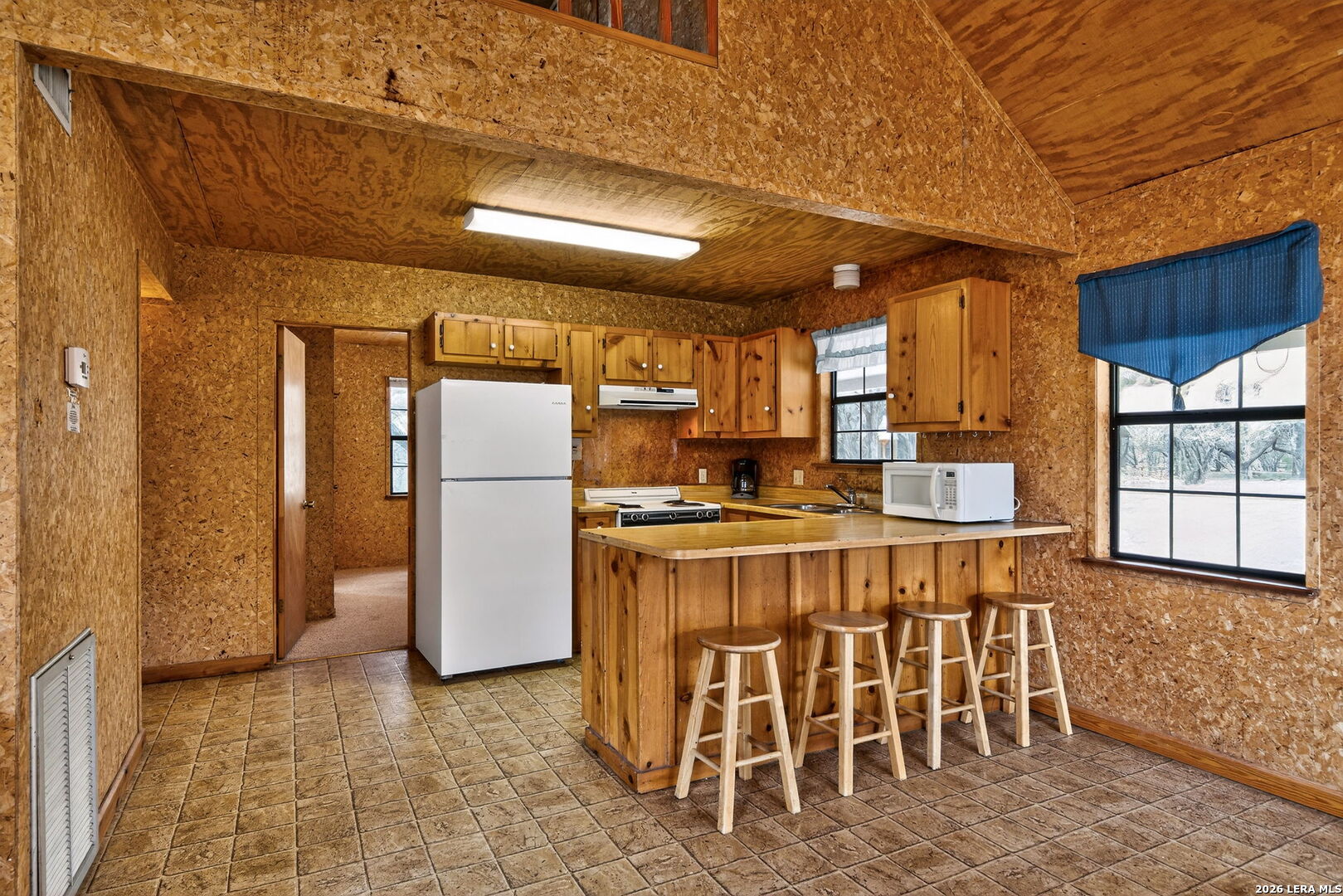 15 Cedar Lane Concan, TX 78838 - Photo 15 of 50 a kitchen with refrigerator and windows