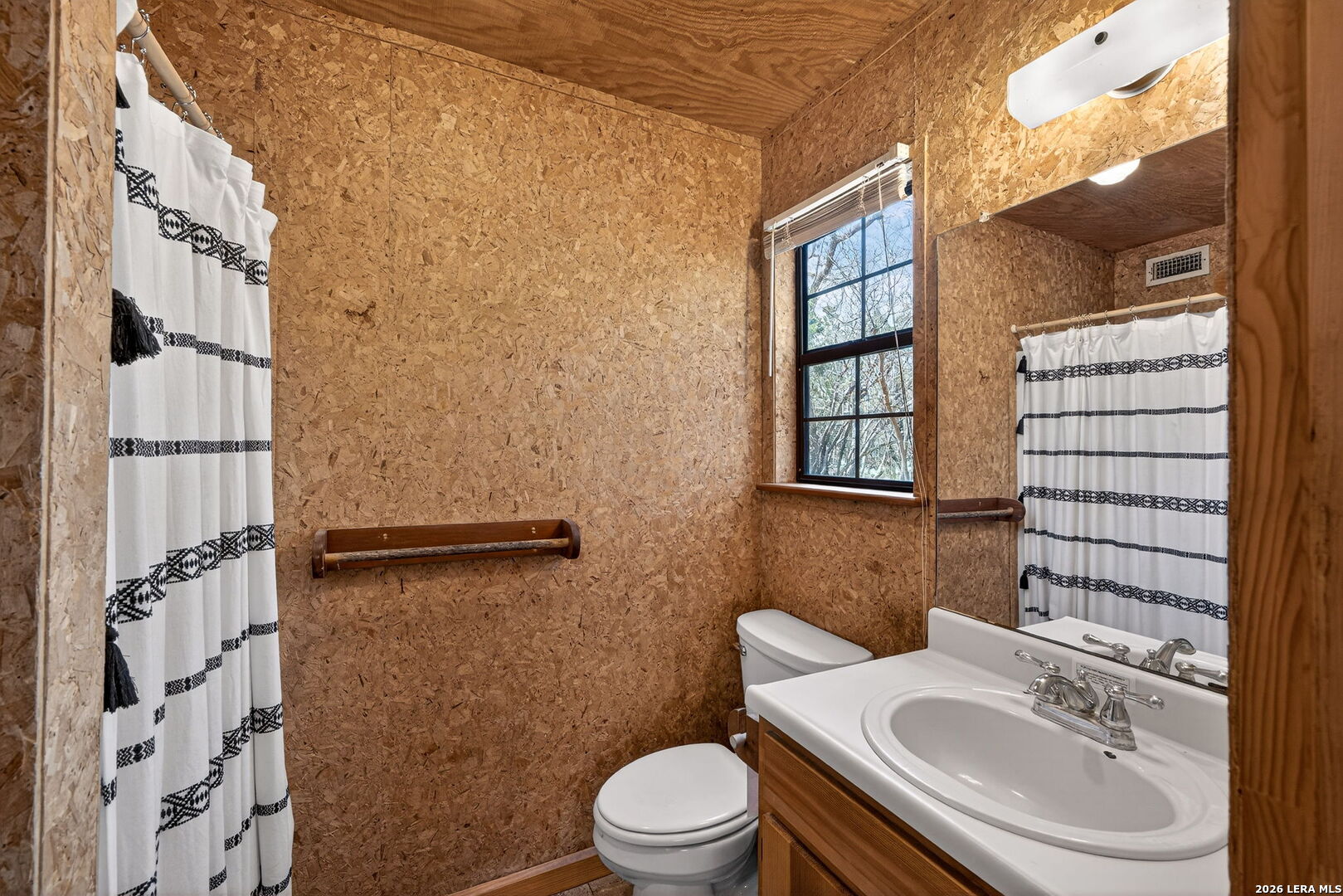 15 Cedar Lane Concan, TX 78838 - Photo 20 of 49 a bathroom with a sink a toilet and shower curtain