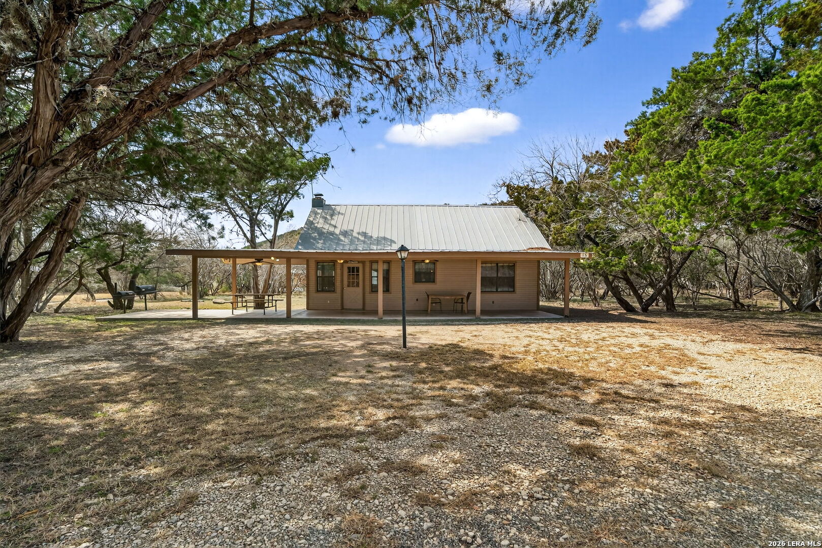 15 Cedar Lane Concan, TX 78838 - Photo 2 of 49 a front view of a house with a yard