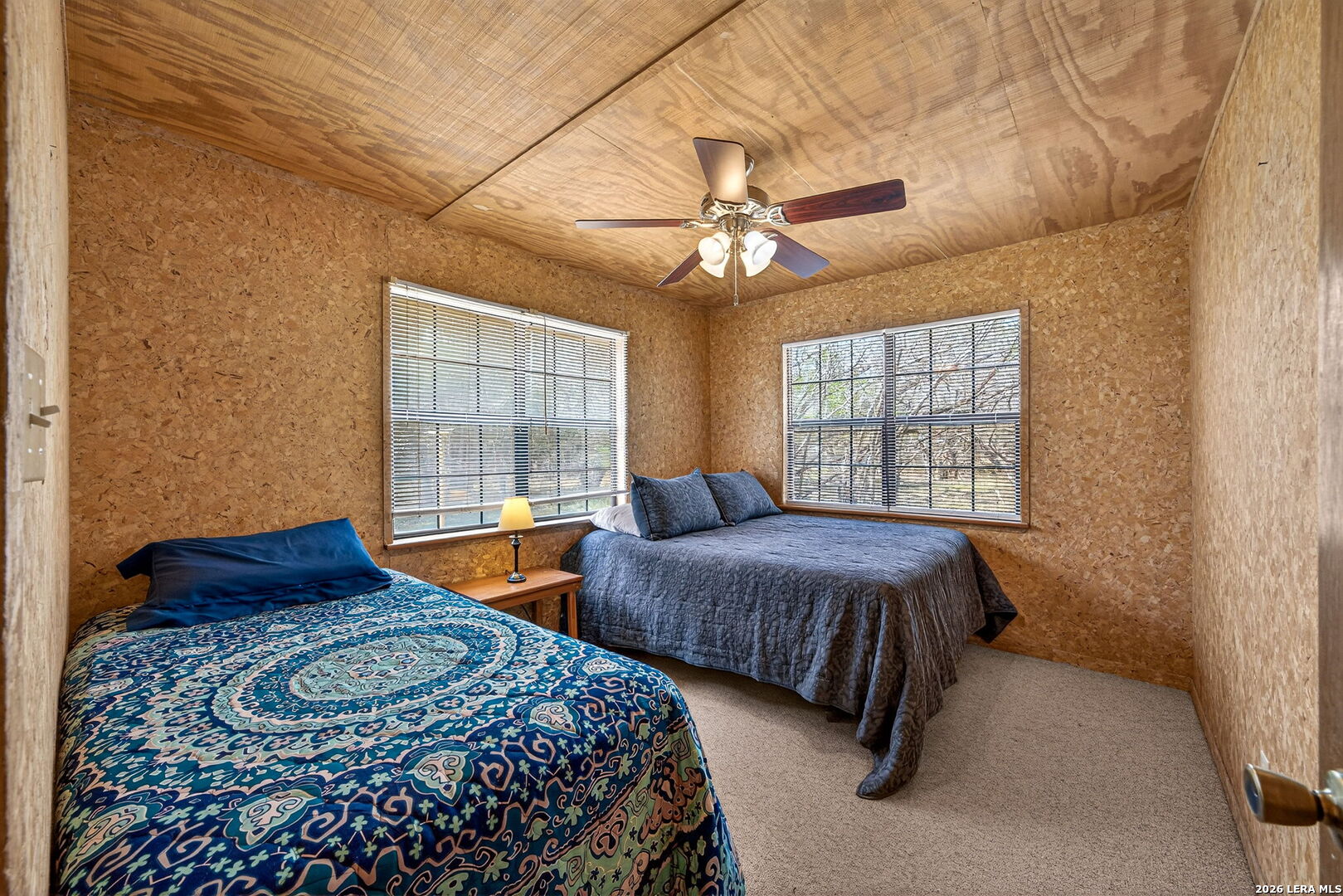 15 Cedar Lane Concan, TX 78838 - Photo 23 of 50 a bedroom with two beds and a window
