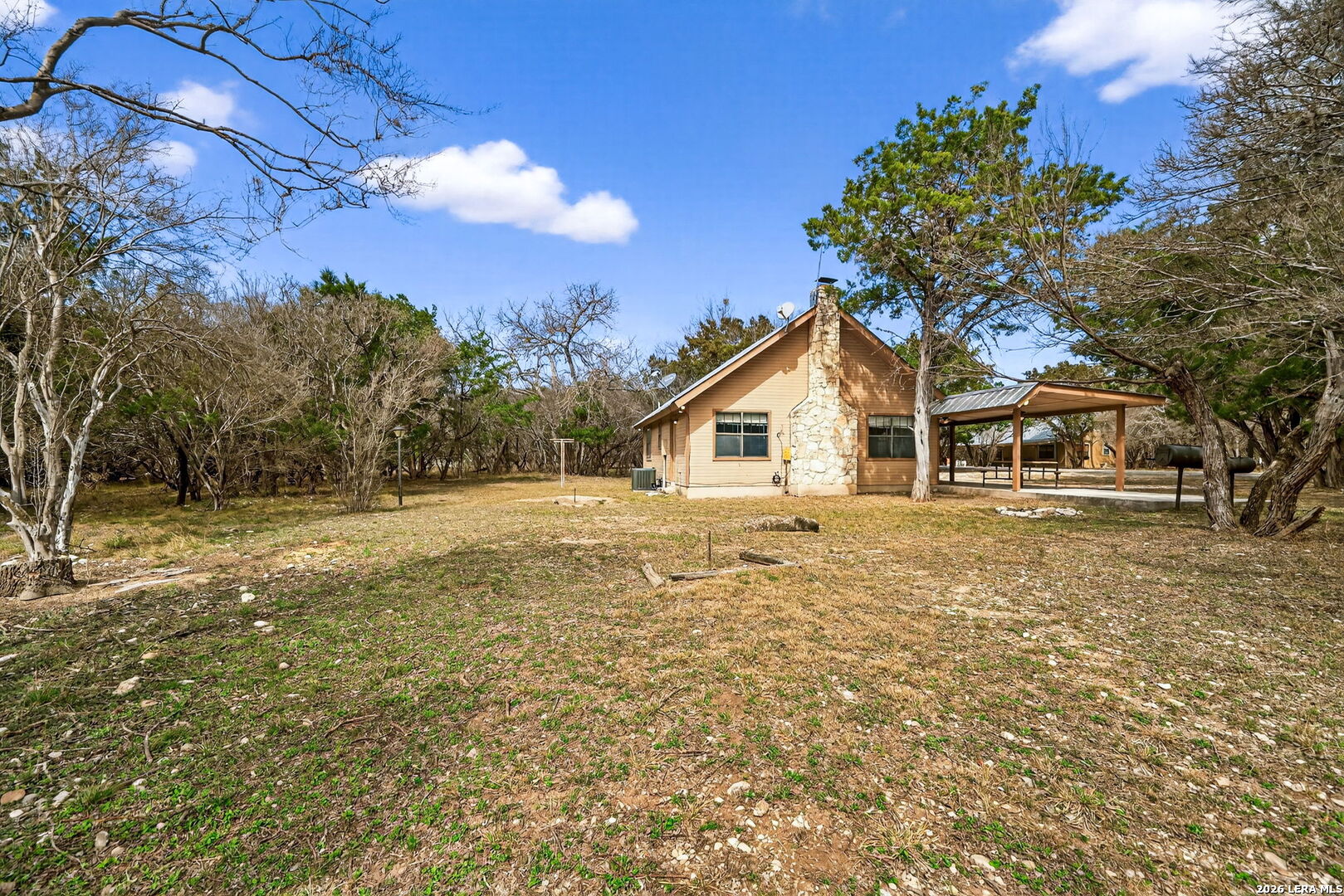 15 Cedar Lane Concan, TX 78838 - Photo 30 of 49 a house with trees in the background