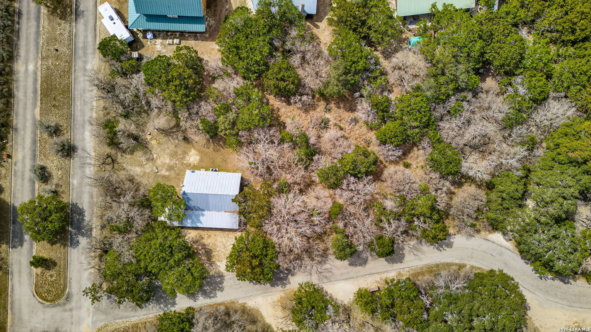 15 Cedar Lane Concan, TX 78838 - Photo 36 of 49 an aerial view of a house with a yard and trees