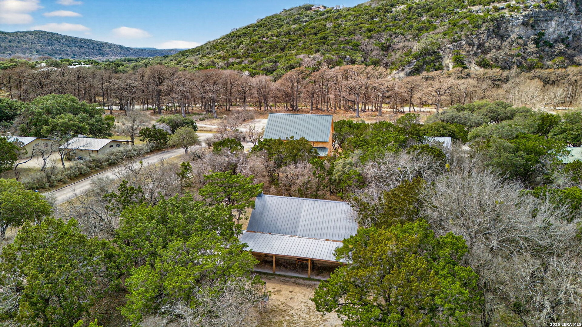 15 Cedar Lane Concan, TX 78838 - Photo 37 of 49 an aerial view of a house with a yard and lake view