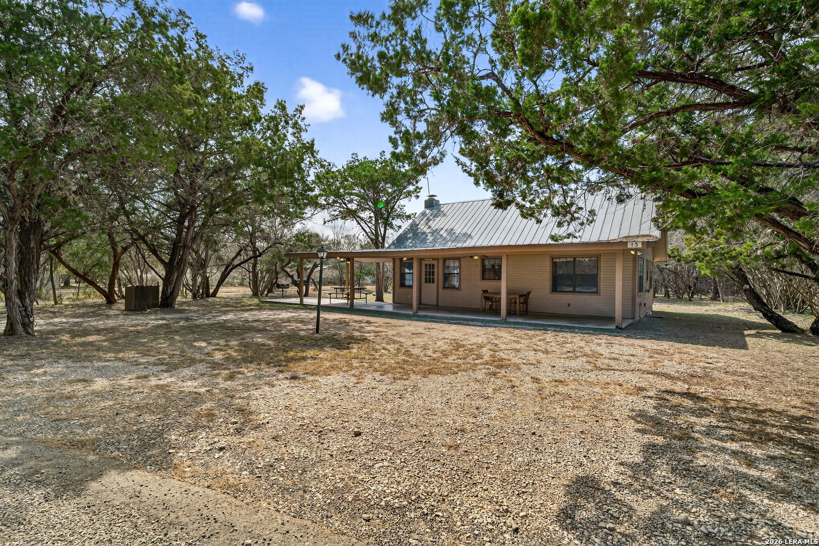 15 Cedar Lane Concan, TX 78838 - Photo 4 of 49 a front view of a house with a yard and garage