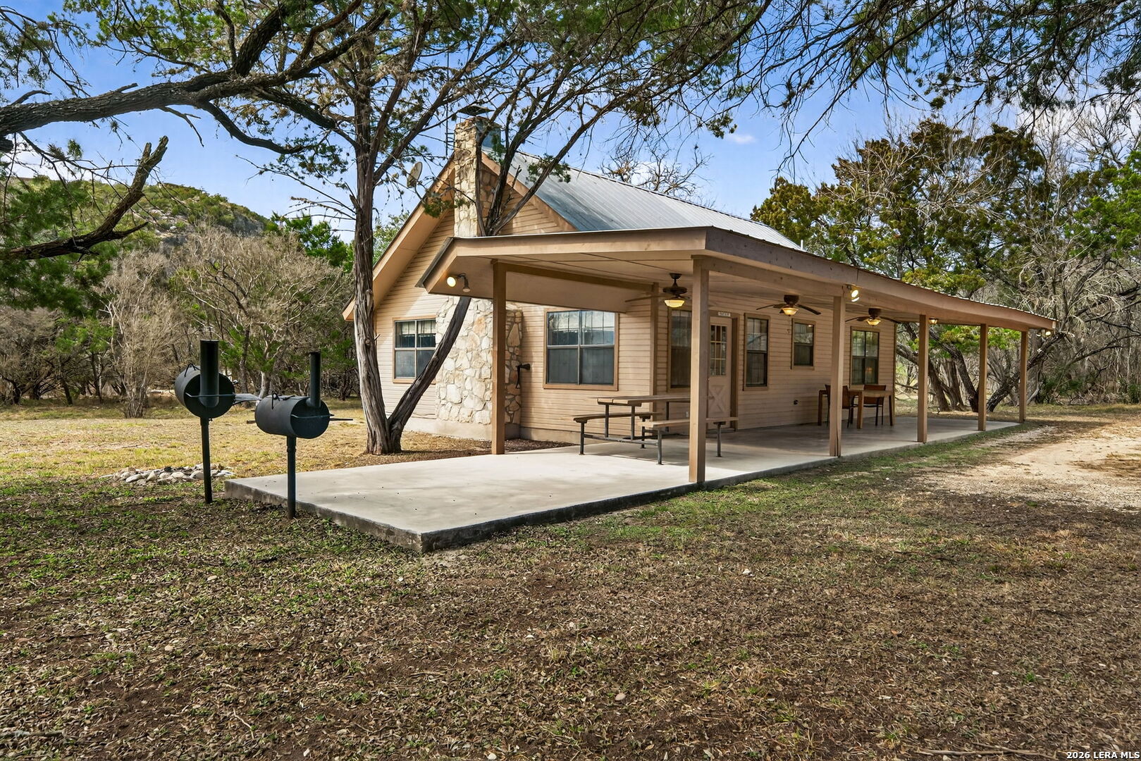 15 Cedar Lane Concan, TX 78838 - Photo 6 of 49 a view of a house with backyard and a tree